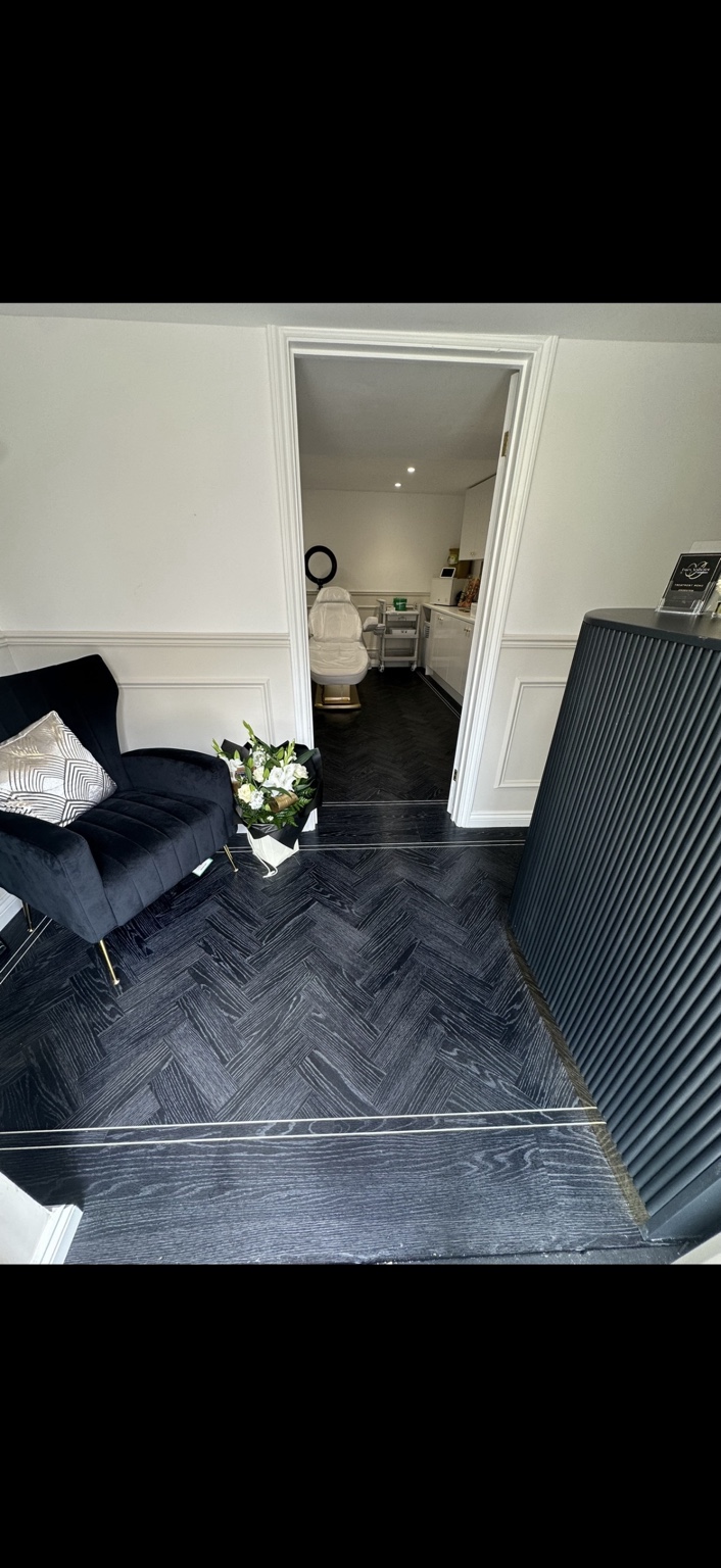 Dark herringbone flooring installation