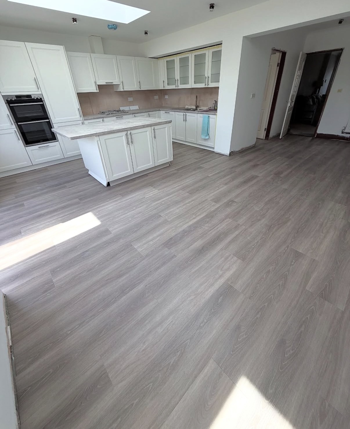 Straight plank flooring in an open plan kitchen
